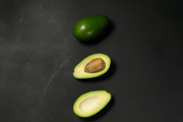 istock Fresh, raw avocado sliced on a black 1182714359