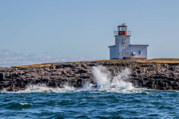 waves crashing on the shore at Grand Passage Lighthouse waves crashing on the rocks at Grand Passage Lighthouse at Wesport, Brier Island, Nova Scotia on an autumn day 7944 stock pictures, royalty-free photos & images