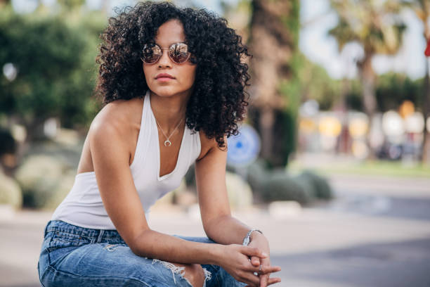 istock Curly woman sitting on the bench 1182716621