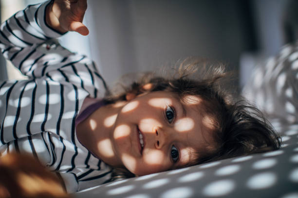 istock Adorable girl waking up 1182717343