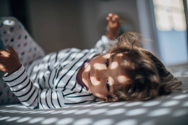 istock Adorable little girl waking up 1182718043
