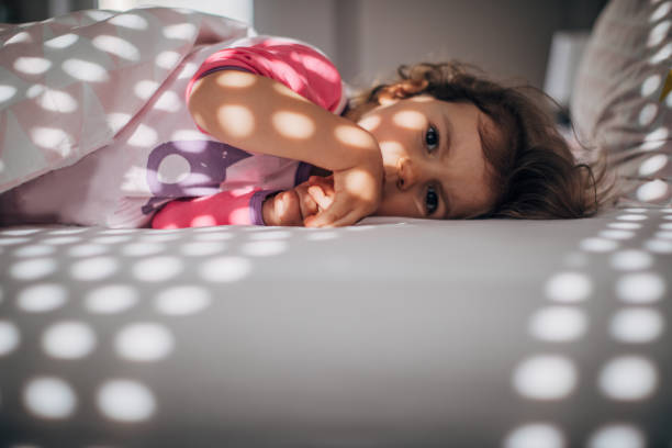 istock Cute little girl waking up 1182718208