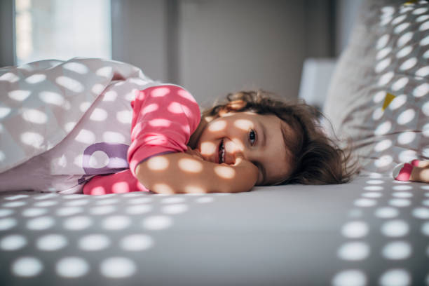 istock Cute little girl waking up 1182718244