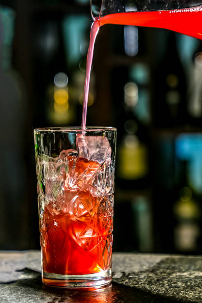 istock The bartender pours red juice or juice into a cocktail glass Cape Cod or Cape Codder 1182722053