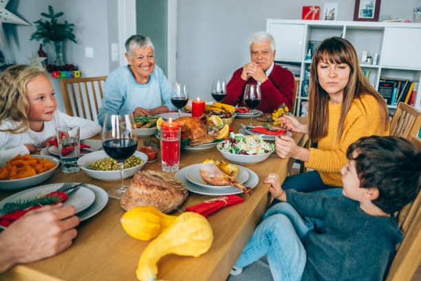 istock Multi-generation family having fun on a holiday dining table. 1182722246