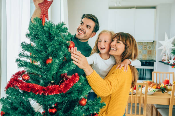 istock Cheerful family decorating the Christmas tree 1182722255