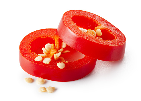 Sliced red jalapeno peppers on a white background