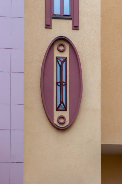 istock A beautiful oval window with an unusual design, the facade of a modern building. Rectangular metal grill on an oval window 1182724958