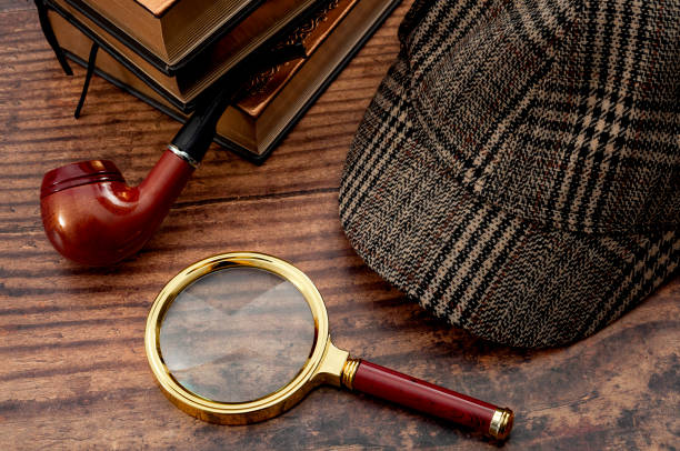 Literary fiction, police inspector, investigate crime and mystery story conceptual idea with sherlock holmes detective hat, smoking pipe, retro magnifying glass and book isolated on wood table top Literary fiction, police inspector, investigate crime and mystery story conceptual idea with sherlock holmes detective hat, smoking pipe, retro magnifying glass and book isolated on wood table top magnifying glass photos stock pictures, royalty-free photos & images