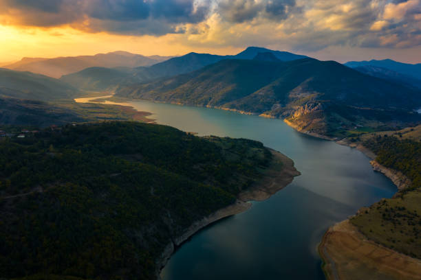 istock Big river passing through the mountains during epic sunset 1182730667