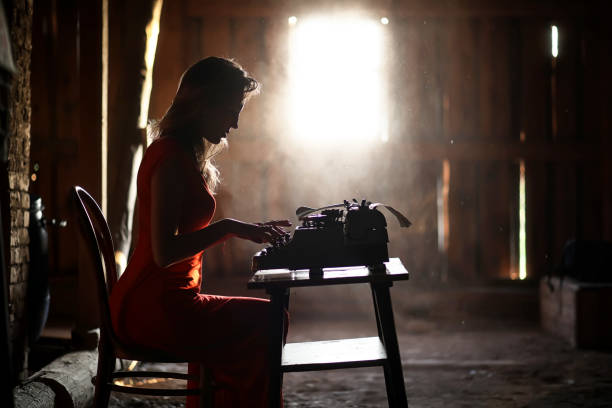 istock A girl in retro style prints on an old typewriter 1182734607