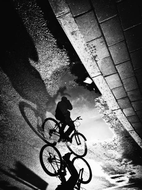 istock Monochrome view of cyclist reflection and shadow 1182736857