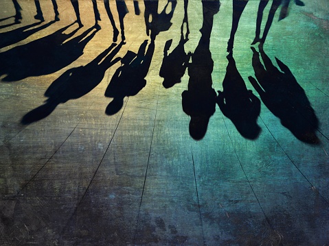 Shadows of group of people walking on the street