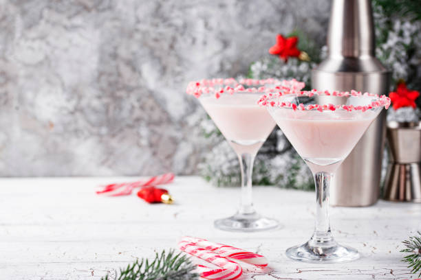 Pink peppermint martini with candy cane rim stock photo