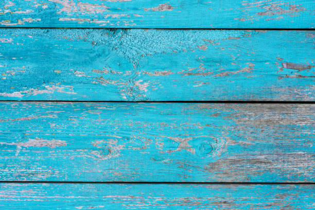 istock old wooden fence blue paint peeling board texture. Background 1182740030