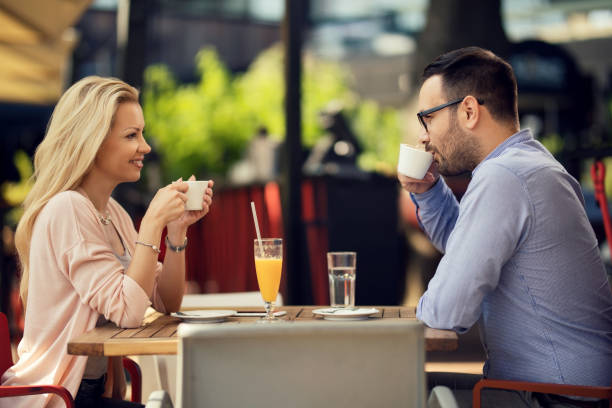 istock Smiling couple drinking coffee and talking in a cafe. 1182740997