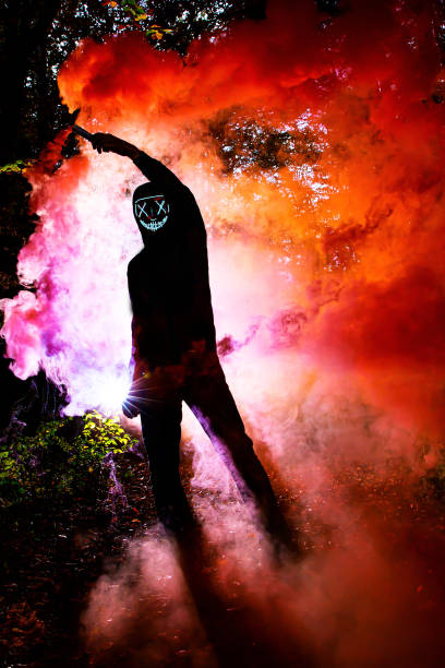 istock Man in the forest with smoke bomb 1182741148
