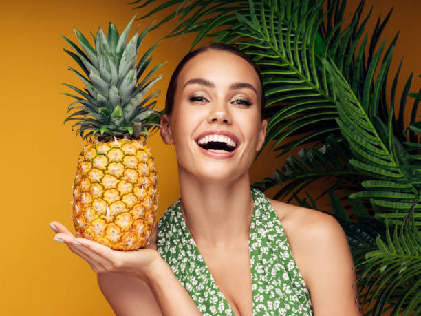 istock Beautiful girl with pineapple 1182741187