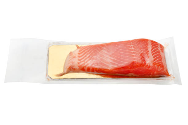 istock Red fish in a vacuum on a white background. Vacuum-packed salmon close-up. 1182741285