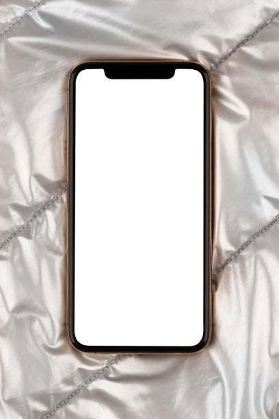 istock Smartphone with a blank white screen. New popular smartphone on silver cloth. 1182742373