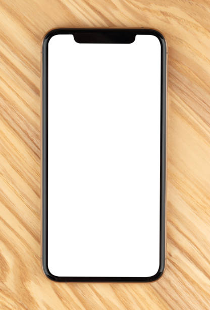 istock Smartphone with a blank white screen. New popular smartphone on a wooden surface. 1182742389