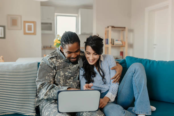 istock Army Man With His Wife Using Laptop 1182744220