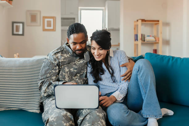 istock Army Man With His Wife Using Laptop 1182744252