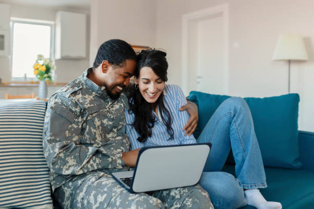 istock Army Man With His Wife Using Laptop 1182744312