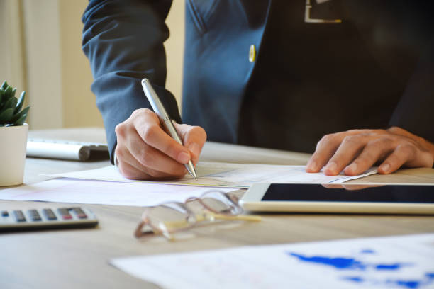 istock A businessman analyzing business graphs on the office desk 1182745109