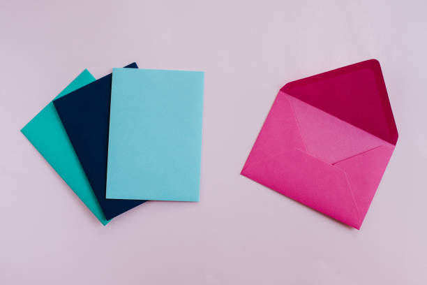 istock Colored paper envelopes on a light background. New mail, write message. Send and receive letter. Postal delivery service. Blank envelope, empty space. People communication, paperwork. Envelope closeup 1182745124
