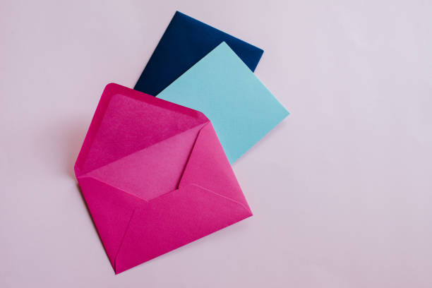 istock Colored paper envelopes on a light background. New mail, write message. Send and receive letter. Postal delivery service. Blank envelope, empty space. People communication, paperwork. Envelope closeup 1182745125