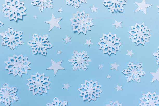 istock Paper pattern with snowflakes and stars 1182745463