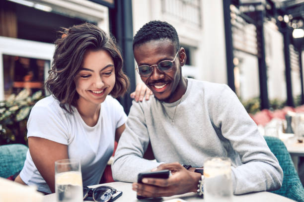 istock Cute Multiethnic Couple Searching For A Specific Place To Visit While Relaxing 1182745736
