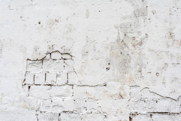 istock texture of a white wall with a damaged stucco layer, architecture abstraction background 1182745742