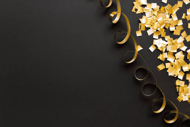 istock Background with golden glitter and spiral ribbon 1182746497