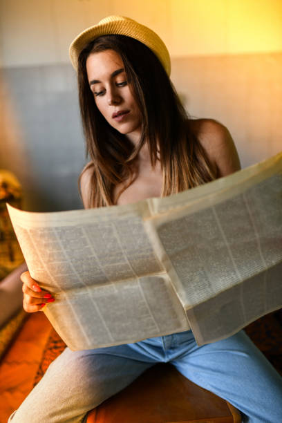 istock Female Enjoying Reading Newspaper In The Kitchen 1182746586