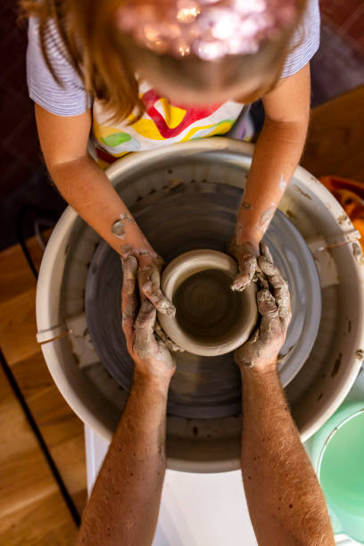 istock Adult and child working as a potters team 1182747846