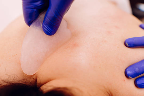 istock Therapist performing Gua Sha massage on woman 1182748903