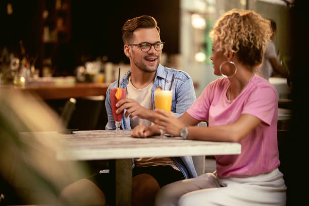 istock Happy couple talking while drinking cocktails in a bar. 1182750168