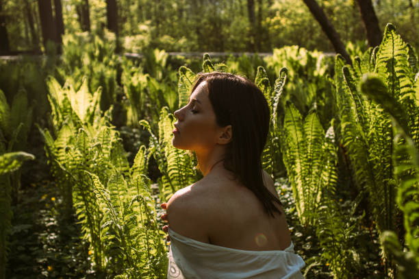 istock Beautiful brunette girl posing in fern 1182751237