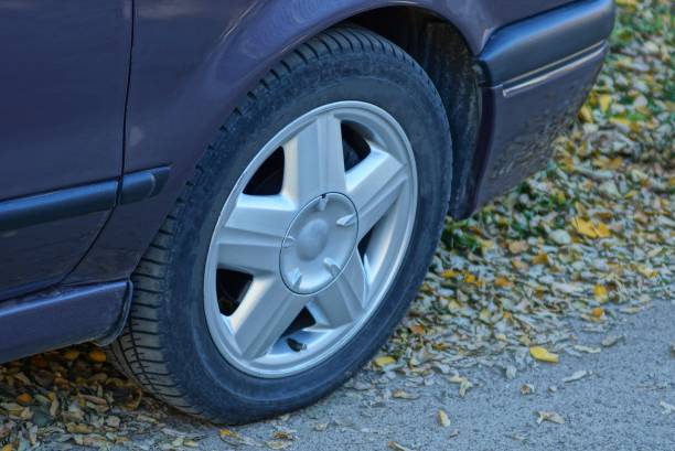 istock car with a one wheel on the asphalt 1182755263