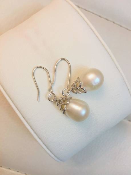 Close up of pearl necklace and jewel gemstone diamond jewelry with copy space for wedding