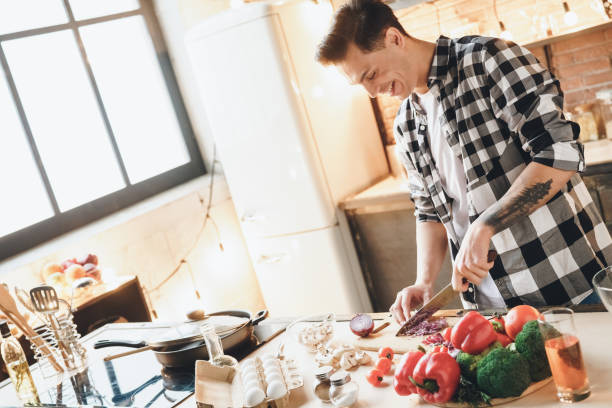 istock Beautiful happiness man making salad at home 1182762446