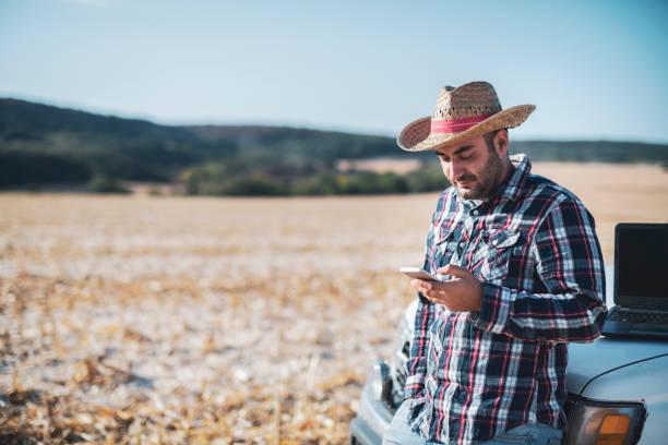 istock Farmer manage harvesting on field. 1182762572