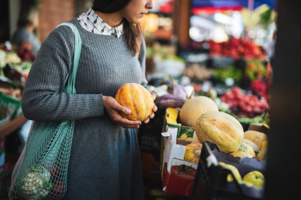 istock Woman choosing melon. 1182762584