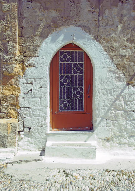 istock arched shaped ancient ottoman style door with a whitewashed stone surround and cobblestone pavement in rhodes town greece 1182763846