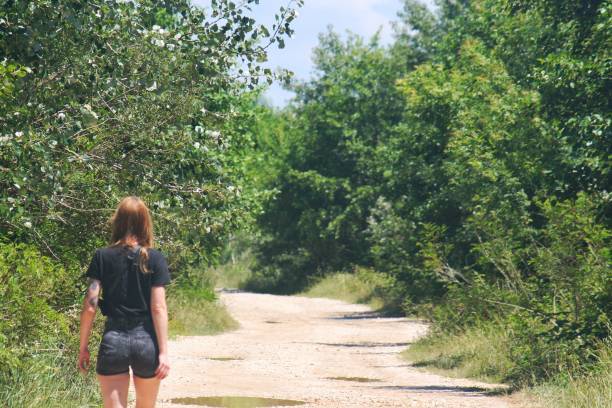 istock Redhead girl walking on forest path Ada Bojana Montenegro 1182764647