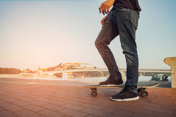 istock male on longboard by the river 1182765602
