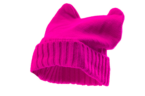Feminism, social rebellion and struggle feminist values conceptual idea with pink knitted pussy hat with cat ears isolated on white background and clipping path cutout using ghost mannequin technique