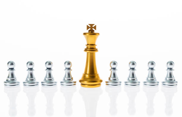 istock Golden king and silver pawns in a white background 1182774233
